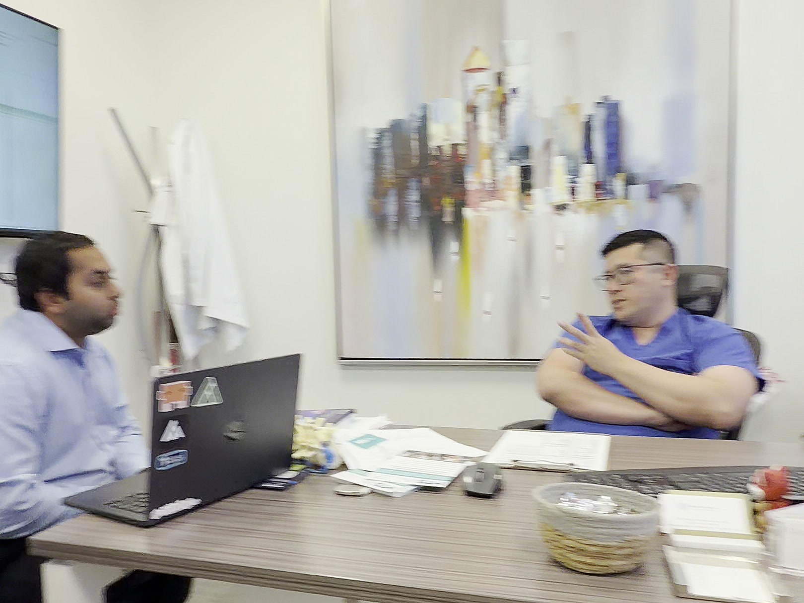 Dr. Jason Liauw talking with the Mira team at his office